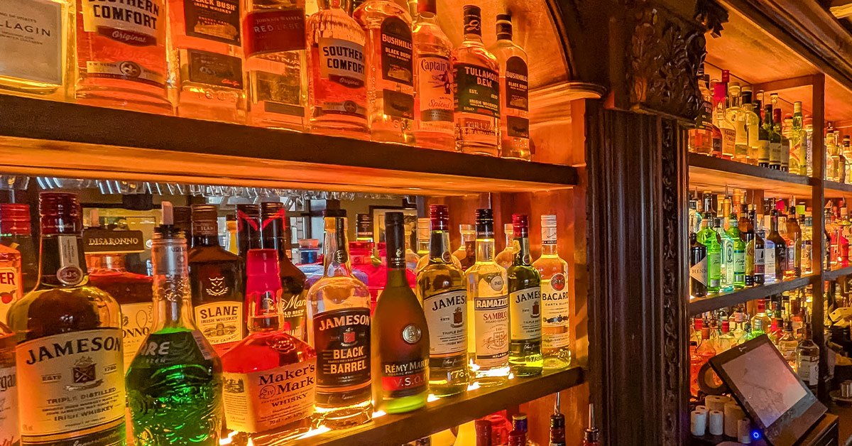 Illuminated cabinets holding a collection of Irish whiskey bottles